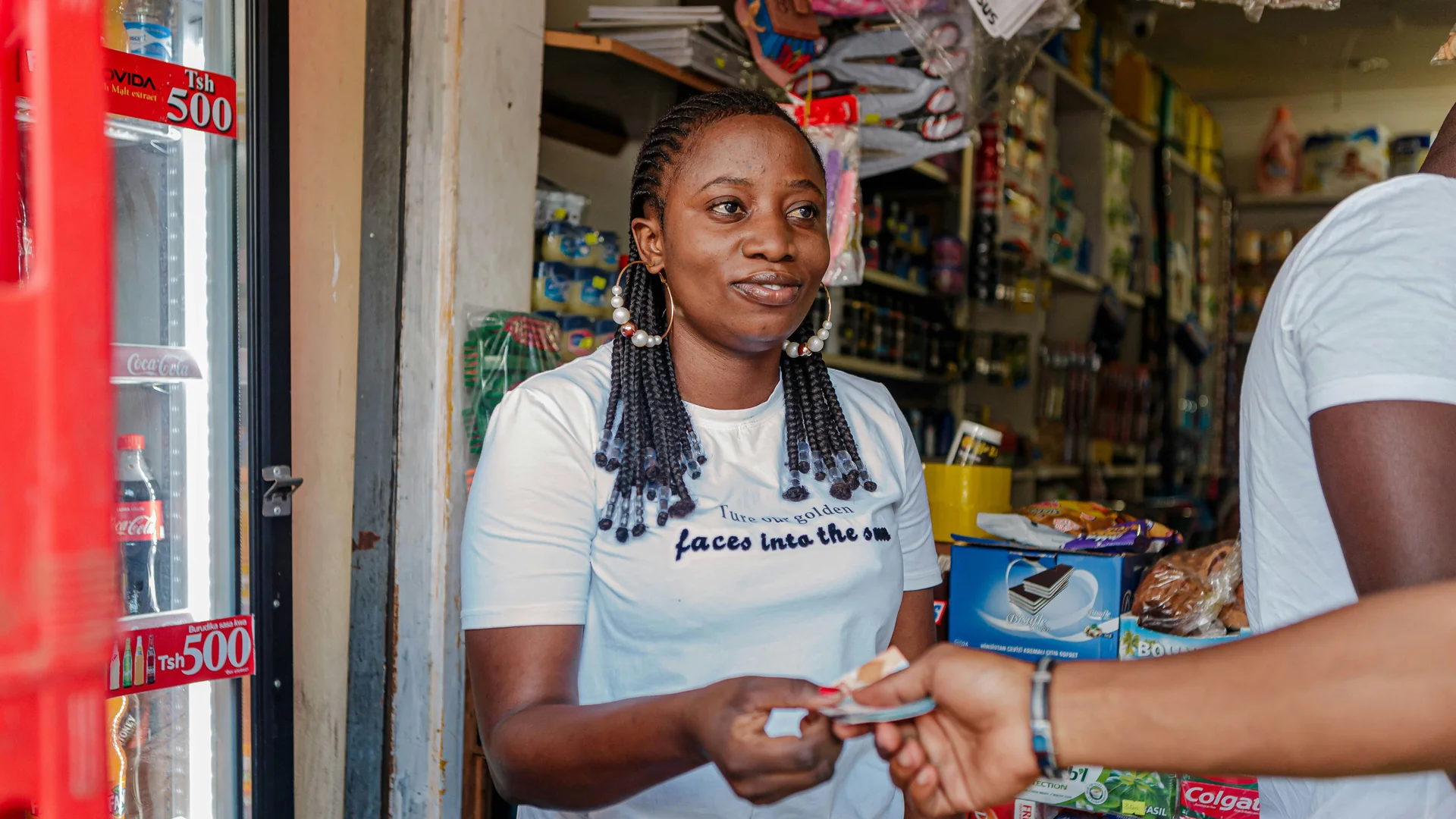 African small-business owner serving a customer